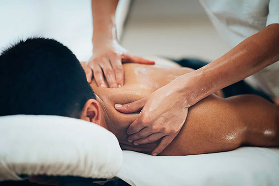 A close up shot of a person receiving a level 3 sports massage on their shoulders